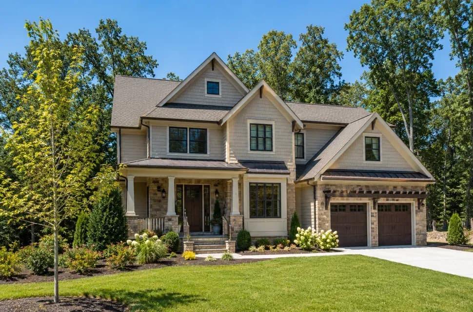 A custom craftsman home with stone accents and a two-car garage built by Build Moore Exteriors in the Triangle, NC